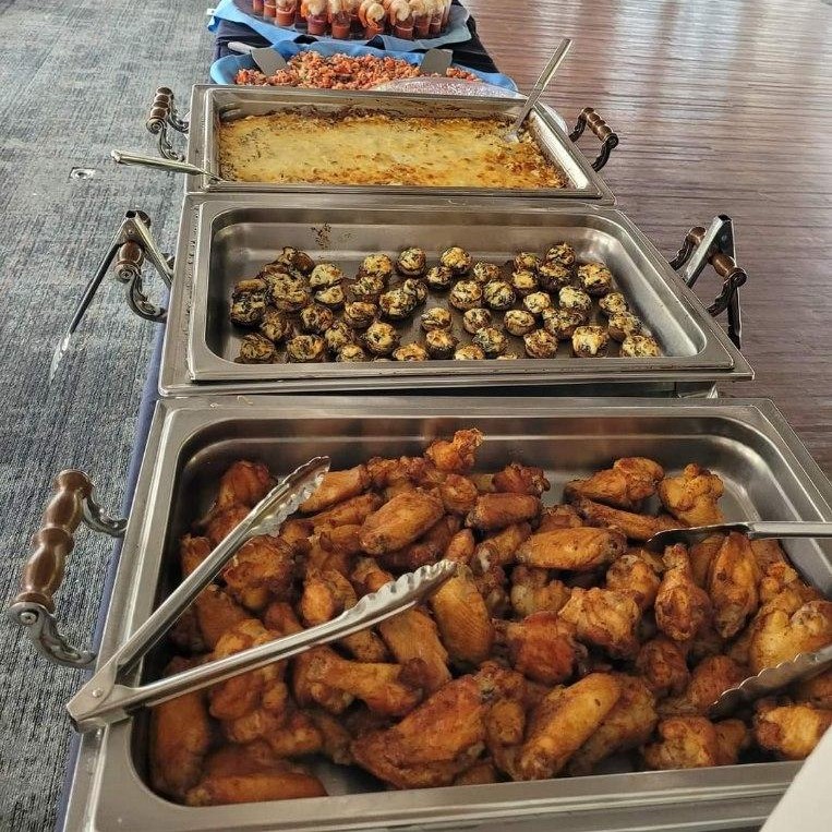 A delightful buffet spread at an MSU club, showcasing a variety of delectable dishes for fraternity parties A delightful buffet spread at an MSU club, showcasing a variety of delectable dishes for fraternity parties