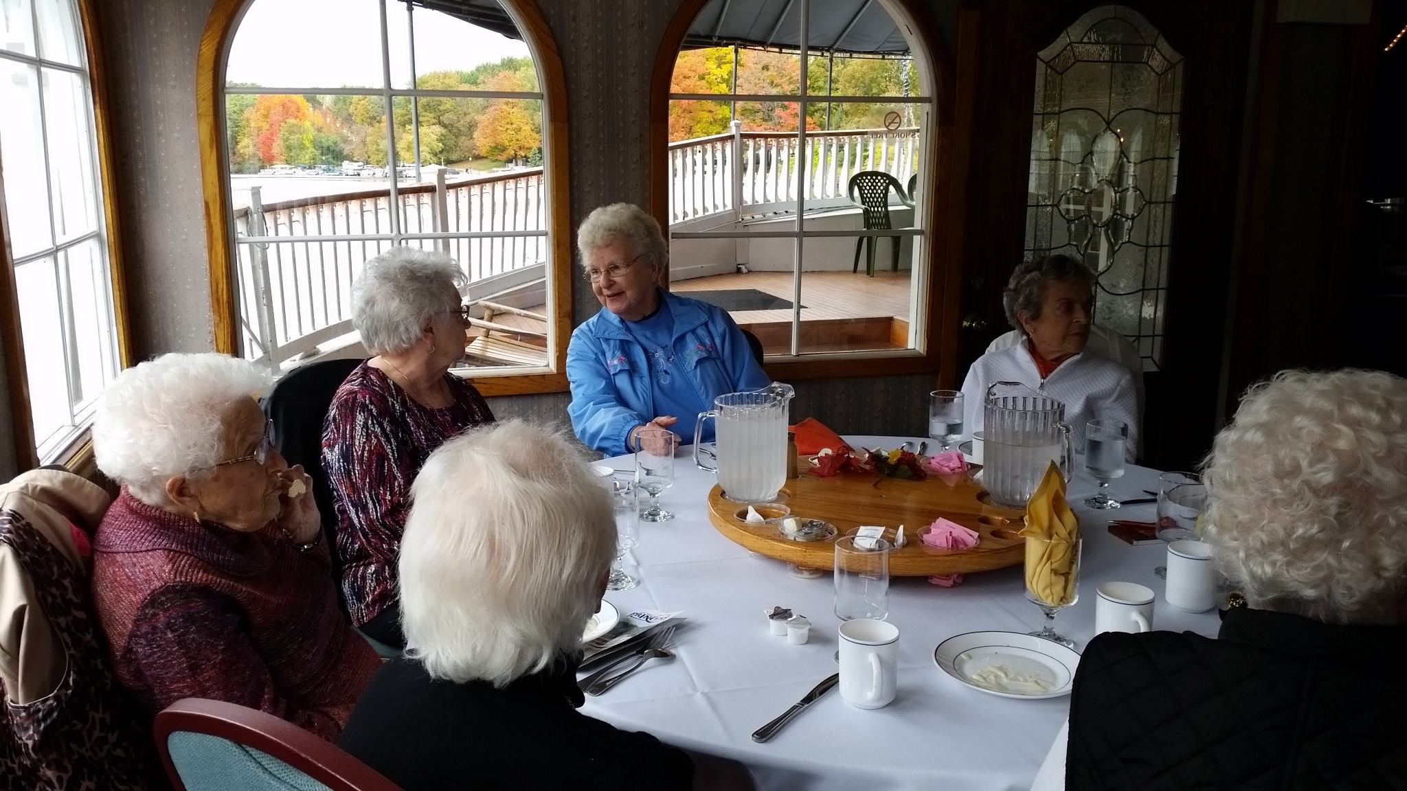 A group of seniors enjoying lunch on a riverboat for senior activities event near me